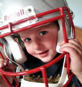 Picture of two year old trying on NFL helmet